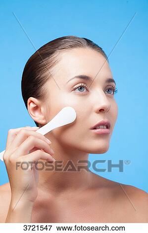 Young woman using makeup spatula View Large Photo Image Stock Photo - Young woman using makeup spatula. Fotosearch