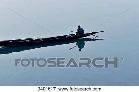 Africa, Mali, fisherman in a dugout in front of the city of Segou View Large Photo Image Stock Photo - Africa, Mali, fisherman in a dugout in front of the city of Segou. Fotosearch