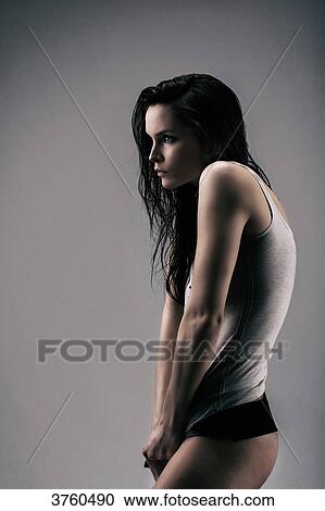 Athletic young girl in profile stretching his shirt View Large Photo Image Stock Image - Athletic young girl in profile stretching his shirt. Fotosearch