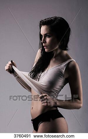 Athletic young girl in profile stretching his shirt View Large Photo Image Stock Image - Athletic young girl in profile stretching his shirt. Fotosearch
