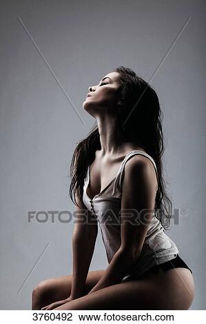 Athletic young girl, seated, in profile, his head up View Large Photo Image Stock Image - Athletic young girl, seated, in profile, his head up. Fotosearch