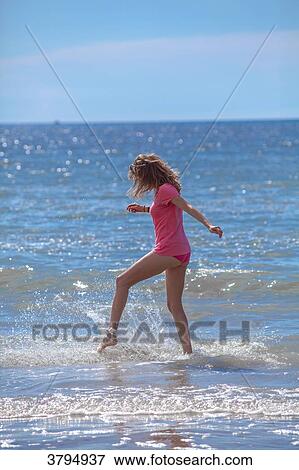 Stock Photo - Attractive young women playing in the water, Pas de Calais, Bitch.. Fotosearch