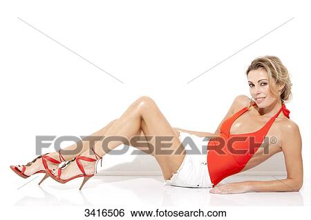 Blond woman lying on the floor, standing on her forearm and posing in studio View Large Photo Image Stock Photograph - Blond woman lying on the floor, standing on her forearm and posing in studio. Fotosearch