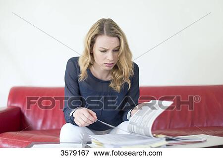 Blonde woman overwhelmed with bills View Large Photo Image Stock Photo - Blonde woman overwhelmed with bills. Fotosearch