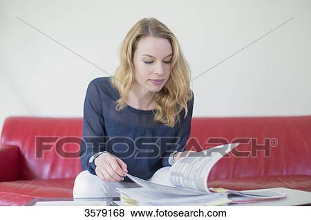 Blonde woman with bills at home View Large Photo Image Stock Photo - Blonde woman with bills at home. Fotosearch