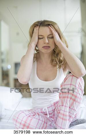 Blonde woman with headache in bed View Large Photo Image Stock Photo - Blonde woman with headache in bed. Fotosearch