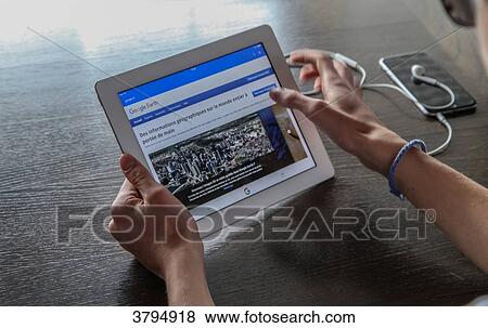 Boy lookinf for Google Earth information on a tablet View Large Photo Image Stock Photo - Boy lookinf for Google Earth information on a tablet. Fotosearch