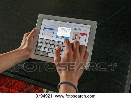 Boy lookinf for information on a tablet View Large Photo Image Stock Image - Boy lookinf for information on a tablet. Fotosearch