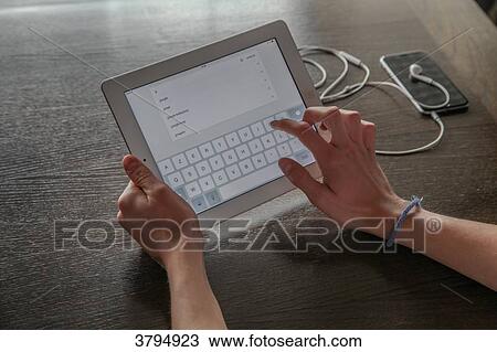 Boy lookinf for information on a tablet View Large Photo Image Stock Image - Boy lookinf for information on a tablet. Fotosearch