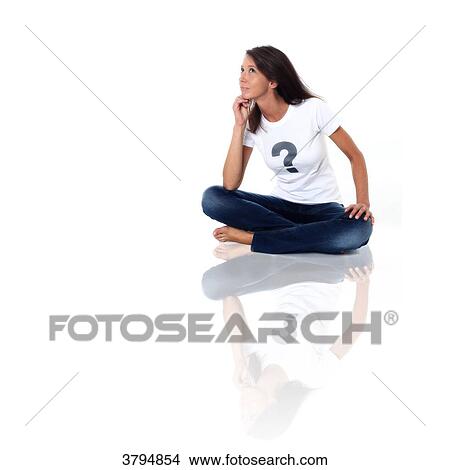 Brown woman in studio wearing a tee shirt with a question mark and pensive air. Conceptual image on the theme Born under X View Large Photo Image Picture - Brown woman in studio wearing a tee shirt with a question mark and pensive air. Conceptual image on the theme Born under X. Fotosearch
