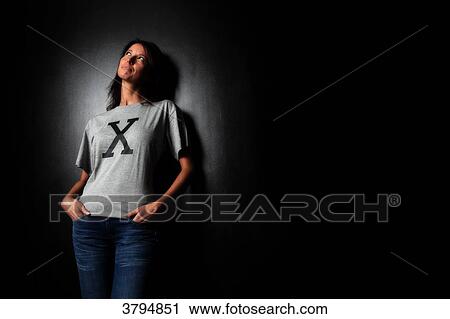 Brown woman in studio with a tee-shirt with an X. Conceptual image on the theme Born under X. View Large Photo Image Stock Image - Brown woman in studio with a tee-shirt with an X. Conceptual image on the theme Born under X.. Fotosearch