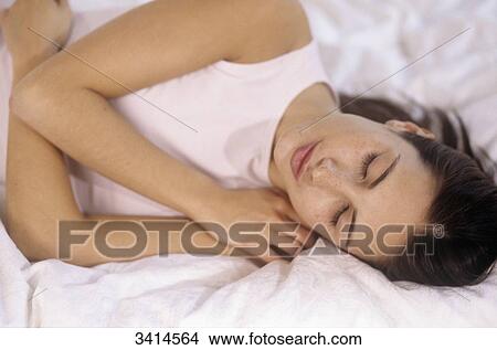 Close-up of a dark haired young woman sleeping View Large Photo Image Picture - Close-up of a dark haired young woman sleeping. Fotosearch