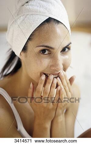 Close-up of a smiling, dark haired young woman holding her hands to her face View Large Photo Image Stock Image - Close-up of a smiling, dark haired young woman holding her hands to her face. Fotosearch