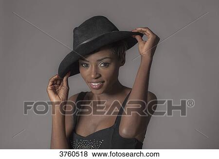 Close up of a young attractive African women with hat View Large Photo Image Stock Photo - Close up of a young attractive African women with hat. Fotosearch
