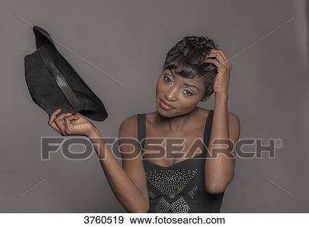 Close up of a young attractive African women with hat View Large Photo Image Stock Photo - Close up of a young attractive African women with hat. Fotosearch