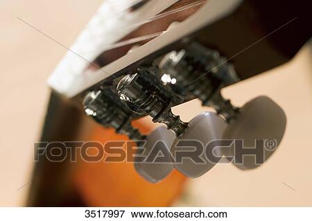 Close-up on the keys of an acoustic guitar. View Large Photo Image Stock Photo - Close-up on the keys of an acoustic guitar.. Fotosearch