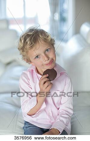 Cute little boy with cookie looking at camera View Large Photo Image Stock Photograph - Cute little boy with cookie looking at camera. Fotosearch