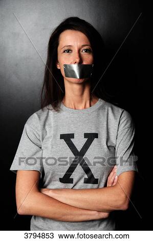 Femme brune en studio avec un tee-shirt avec un X et du scotch sur la bouche. Image conceptuelle sur le theme Ne sous X. View Large Photo Image Stock Image - Femme brune en studio avec un tee-shirt avec un X et du scotch sur la bouche. Image conceptuelle sur le theme Ne sous X.. Fotosearch
