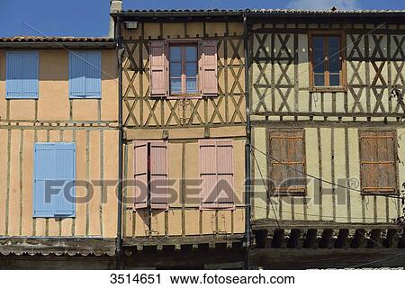 Stock Image - France, Ariege, three medieval half-timbered facades in Mirepoix. Green and purple shutters. Fotosearch