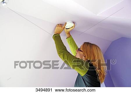 France, around Paris, 42 year old woman in the process of installing the ceiling smoke detector. View Large Photo Image Stock Image - France, around Paris, 42 year old woman in the process of installing the ceiling smoke detector.. Fotosearch