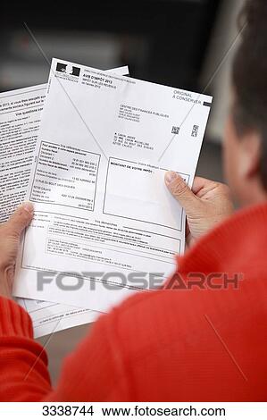 France, Back view of a man holding his tax notice View Large Photo Image Picture - France, Back view of a man holding his tax notice. Fotosearch