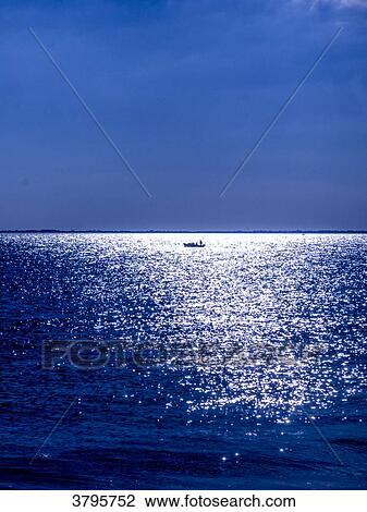 Stock Image - France, Brittany, Gulf of Morbihan, boat in the reflecting moon. Fotosearch
