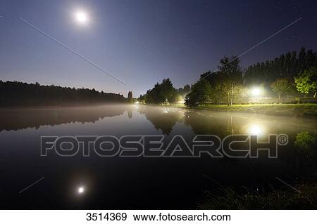 France, Burgundy, Yonne. Saint Sauveur in Puisaye. The pond of Joumiers by night, in lunar atmosphere. View Large Photo Image Stock Photo - France, Burgundy, Yonne. Saint Sauveur in Puisaye. The pond of Joumiers by night, in lunar atmosphere.. Fotosearch