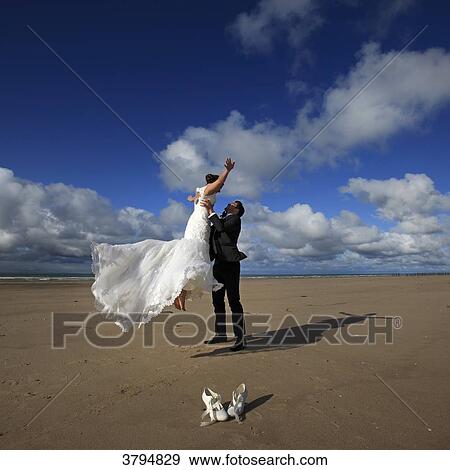 Stock Photo - France, couple of married on the beach.. Fotosearch