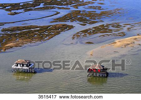 Stock Photo - France, Gironde. Arcachon Bay. Bird Island. Cabin built on stilts.. Fotosearch