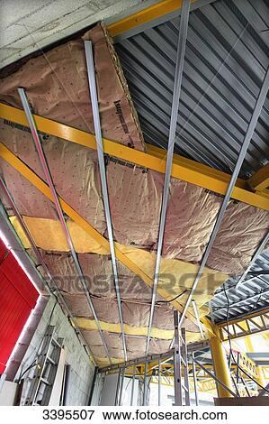 France, House building, ceiling insulation with glass wool panels on suspended metal rails View Large Photo Image Stock Photo - France, House building, ceiling insulation with glass wool panels on suspended metal rails. Fotosearch