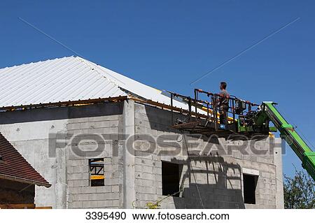 France, House building, handling safety with a lift machine, sandwich panel roof-covering work on industrial steel frame View Large Photo Image Stock Image - France, House building, handling safety with a lift machine, sandwich panel roof-covering work on industrial steel frame. Fotosearch