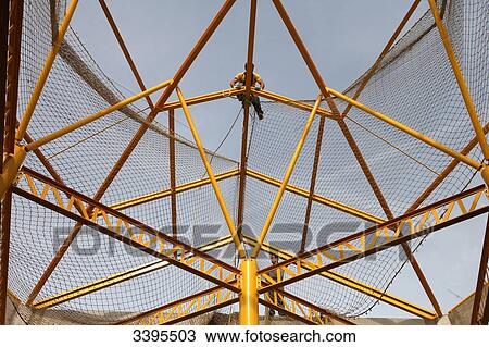France, House building, installation of a safety net for the assembly of a metal covering View Large Photo Image Stock Image - France, House building, installation of a safety net for the assembly of a metal covering. Fotosearch