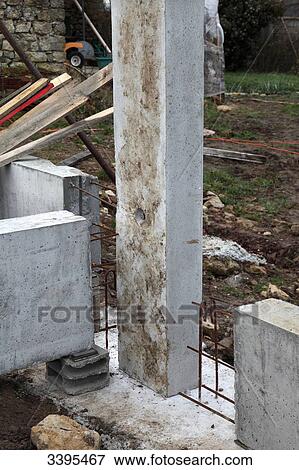 France, House building, installation of a concrete beam on a concrete footing for a house's foundations. Safety with regard to the handling of elements with a crane. Reinforcement View Large Photo Image Stock Photo - France, House building, installation of a concrete beam on a concrete footing for a house's foundations. Safety with regard to the handling of elements with a crane. Reinforcement. Fotosearch