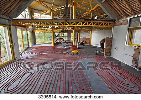 Picture - France, House building, installing a heat pump and a floor heating system, pavement markers for the height of the concrete slabFrance,. Fotosearch