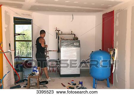 France, House building, installing a heat pump and a floor heating system View Large Photo Image Stock Image - France, House building, installing a heat pump and a floor heating system. Fotosearch