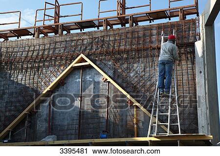 France, House building, raising the house's walls. Safety on a scaffold/scale. installation of an iron framework for the construction of a concrete wall View Large Photo Image Stock Image - France, House building, raising the house's walls. Safety on a scaffold/scale. installation of an iron framework for the construction of a concrete wall. Fotosearch