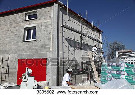France, House building, safety on a scaffold/scale. masons making an exterior plaster on the facade View Large Photo Image Stock Image - France, House building, safety on a scaffold/scale. masons making an exterior plaster on the facade. Fotosearch
