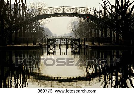 France, Ile de France, Paris, 10th district, Canal St Martin in twilight, trees in winter, gateway, floodgate, night light View Large Photo Image Stock Image - France, Ile de France, Paris, 10th district, Canal St Martin in twilight, trees in winter, gateway, floodgate, night light. Fotosearch