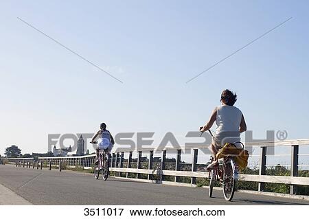 Stock Photo - France, Ile de Noirmoutier, bicycle ride on the Jetee Jacobsen (pier). Fotosearch