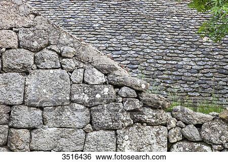 Stock Photograph - France, Lozere, old stone wall and stone tiles roof. Fotosearch