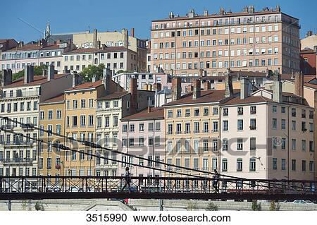 Stock Image - France. Lyon. The footbridge Saint Vincent on the Saone and the facades of the quay Saint Vincent. Fotosearch