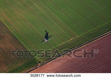 France, Norhern France, Pas-de-Calais. Aerial view of an agricultural vehicle in a field View Large Photo Image Stock Photo - France, Norhern France, Pas-de-Calais. Aerial view of an agricultural vehicle in a field. Fotosearch