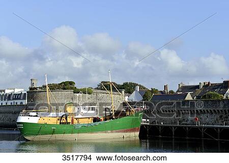 Picture - France, North-Western France, Brittany, Concarneau, port with its battlements and trawler of the Fishing Museum. Fotosearch