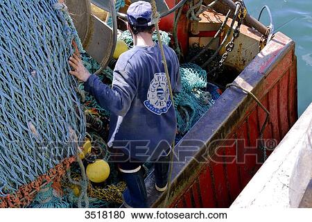 France, North-Western France, Brittany, Le Guilvinec, fishing port, moored trawler, netting under repair View Large Photo Image Stock Image - France, North-Western France, Brittany, Le Guilvinec, fishing port, moored trawler, netting under repair. Fotosearch