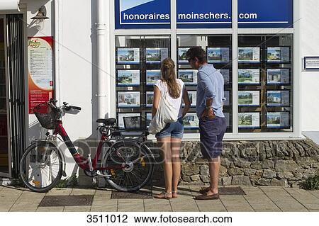 France, North-Western France, Ile de Noirmoutier, Noirmoutier-en-l'Ile, couple in front of a realty agency's showcase View Large Photo Image Stock Image - France, North-Western France, Ile de Noirmoutier, Noirmoutier-en-l'Ile, couple in front of a realty agency's showcase. Fotosearch