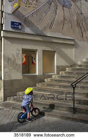 France, North Western France, Nantes, small child on his bicycle at the bottom of staircases. View Large Photo Image Stock Photo - France, North Western France, Nantes, small child on his bicycle at the bottom of staircases.. Fotosearch