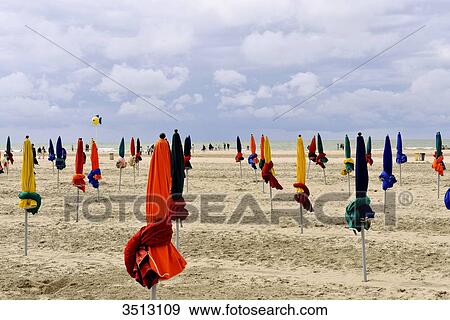 France, Northern France, Lower Normandy, Deauville, seafront, beach before the storm, umbrellas View Large Photo Image Stock Photo - France, Northern France, Lower Normandy, Deauville, seafront, beach before the storm, umbrellas. Fotosearch