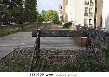 Stock Photo - France, Paris, 15th district, small section of the Chemin de fer de Petite Ceinture (little belt railway) between the rue Saint Charles and the rue Olivier de Serres. Fotosearch