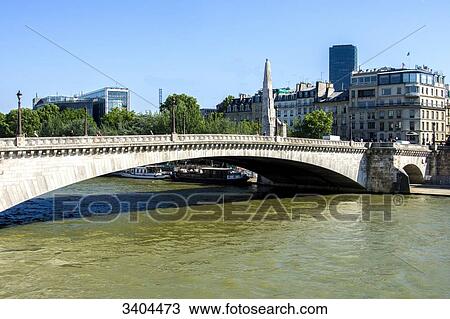 Stock Image - France, Paris 6eme, Pont de la Tournelle bridge above the Seine River with statue of St Genevieve and the famous restaurant La Tour d'Argent on the banks. Fotosearch