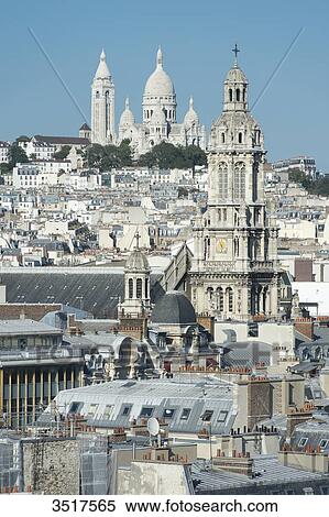 Stock Photography - France. Paris 9th district. Bell tower of the Sainte Trinit church and the Sacre-Cur Basilica. Fotosearch
